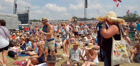 A festival crowd of music fans gathers by the Pyramid Stage at Glastonbury Festival , UK FEATURED