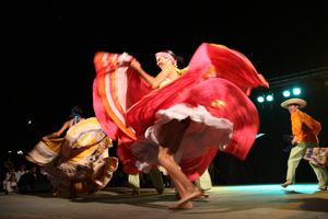A folklore dancing group from Columbia performs during the International Folk Festival Is Pariglias—Assemini, Sardinia. Editorial Credit: Angyalosi Beata / Shutterstock.com 